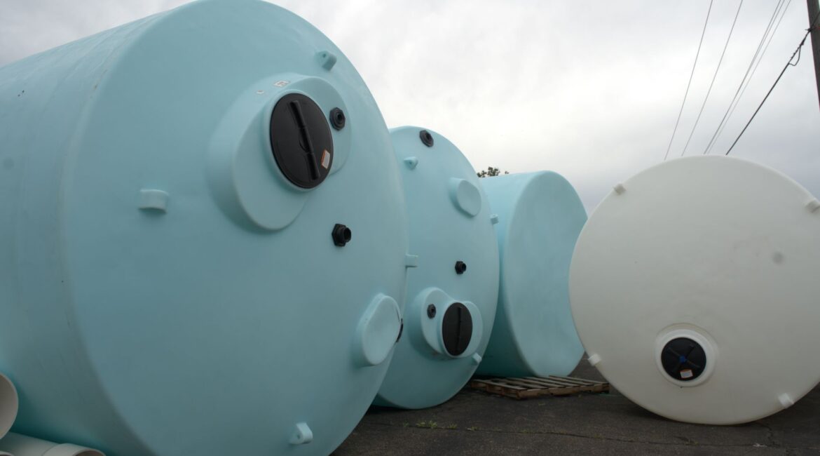 Technician installing custom industrial pipe fittings for a fluid handling system