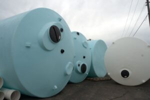 Technician installing custom industrial pipe fittings for a fluid handling system